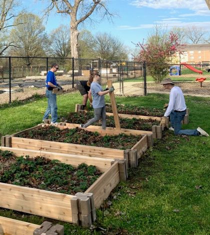 Rotarians build planting beds for downtown preschoolers